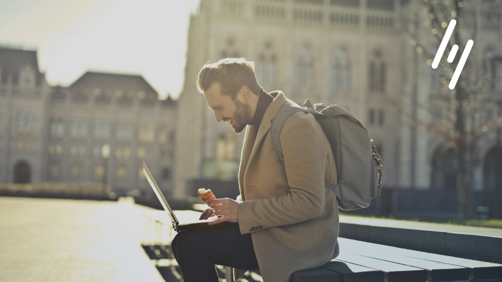 Man sitting with a laptop working internationally.